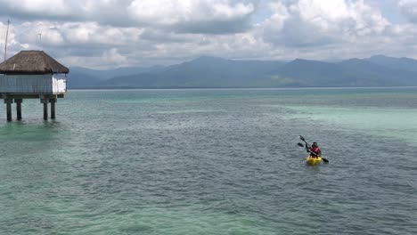 Tourist-Paddling-And-Kayaking-At-The-Honda-Bay-Near-The-Beach-Cottage-Of-Dos-Palmas-Island-Resort-And-Spa-In-Puerto-Princesa,-Palawan,-Philippines