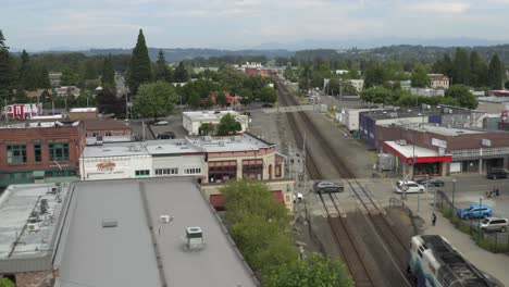 The-Long-Trailway-In-Puyallup-Downtown-Washington-In-Background-With-High-Buildings-And-Trees-Under-The-Bright-Cloudy-Sky---Aerial-Shot