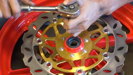 Close-up-Footage-of-Mechanic-Working-On-Disc-Brake-Installation-For-Motorcycle