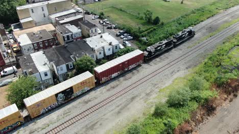 Norfolk-Southern-diesel-locomotives-pull-train-cars-through-Kensington-neighborhood-in-Northeast-Philly