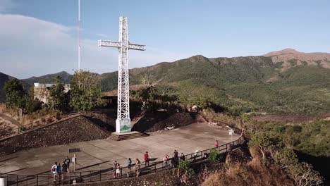 An-aerial-approach-of-a-giant-cross-located-atop-mount-patyas-just-outside-of-the-town-of-Coron,-Palawan,-Philippines