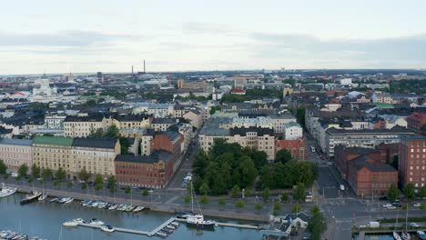 Expansive-aerial-shot-of-Helsinki,-Finland-along-the-waterfront-at-dusk