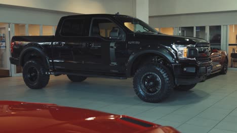 Black-Ford-F150-FX4-Full-Size-Pickup-Truck-in-Dealership-Showroom