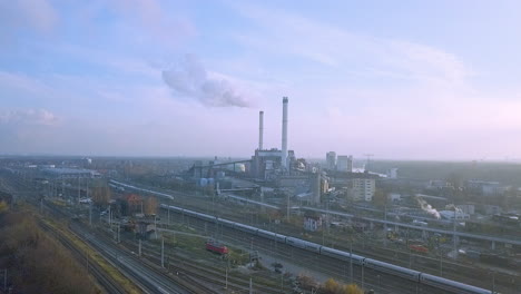drone-hovering-high-above-railroads-heading-towards-a-heating-plant-in-Berlin