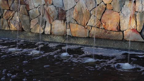 Sunlight-on-urban-rock-wall-water-fountain-helps-create-serene-calm