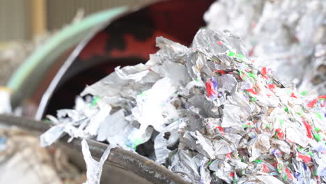 cinematic-shot-of-shredded-milk-cartons-in-recycling-plant