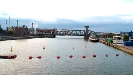 Drone-rises-over-train-bridge-crossing-the-Schelde-river-in-Antwerp-Belgium
