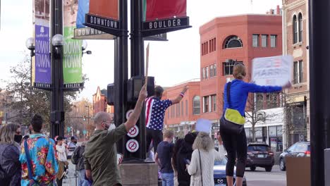 People-celebrating-Joe-Biden's-election-victory-in-the-streets-of-Boulder,-Colorado