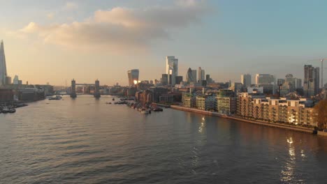 stable-drone-shot-over-London-Thames-river-towards-city-centre-sunset