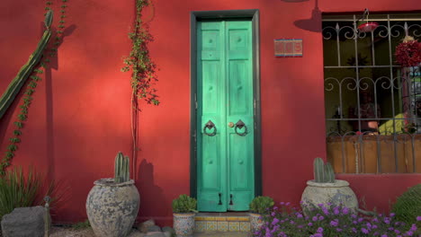 The-green-painted-doorway-of-a-colorful-home-in-Barrio-Viejo,-Tucson,-Arizona---wide-zoom