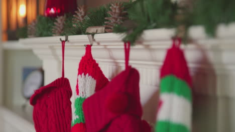 Four-christmas-stockings-hang-on-the-decorated-mantle