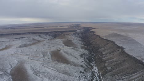 Snowy-canyon-winter-drone-shot-of-expansive-plains