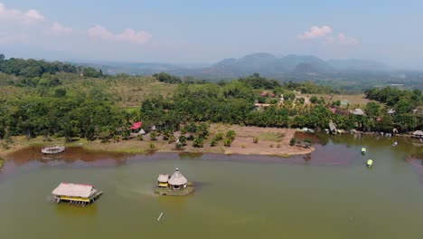 Stunning-4k-aerial-view,-pan-left-to-right-over-the-famous-Laguna-de-los-Milagros-and-the-tropical-rain-forest-in-Tingo-Maria,-the-entry-gate-to-the-Amazon-in-Peru