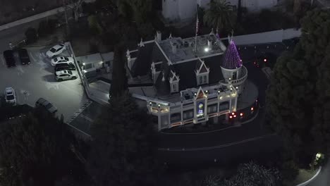 Aerial-static-view,-Magic-castle,-night-time,-in-Los-Angeles,-drone-shot