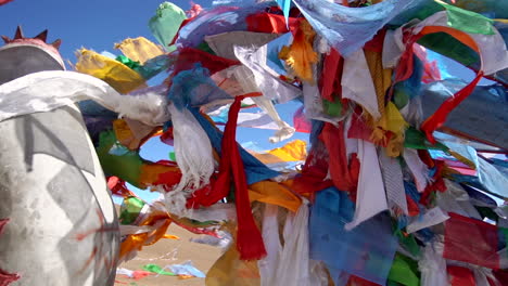 Orbital-shot-of-Buddhist-prayer-flags-swaying-in-the-wind-in-the-mountains