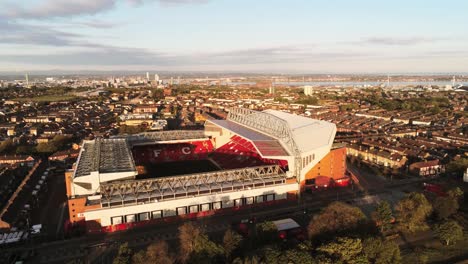 Iconic-Liverpool-Anfield-football-stadium-ground-at-sunrise-aerial-view-wide-orbit-left