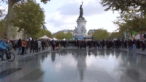 Shot-of-People-Gathering-On-Place-De-La-Republique-in-Honor-of-Samuel-Paty,-The-Teacher-killed-by-a-Terrorist,-Paris-France