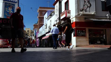 Locked-shot-of-People-wearing-protective-masks-in-a-busy-pedestrian-street-of-Benidorm