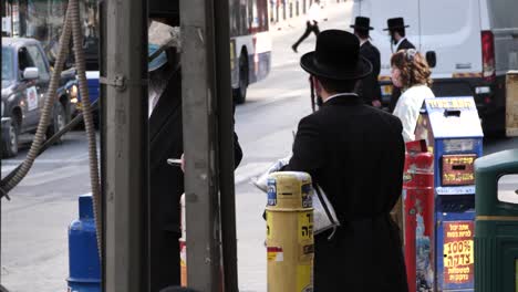 Bnei-Brak-street,-Jewish-man-goes-to-prayer,-wearing-face-mask-improperly