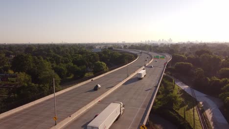 Fisher-Freeway-In-Michigan-With-Detroit-Skyline-In-Distant-Background---ascending-drone