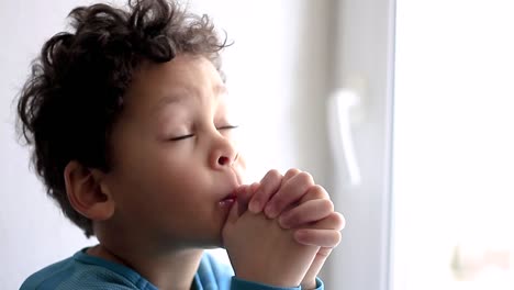 little-boy-praying-to-God-with-hands-together-stock-video-stock-footage