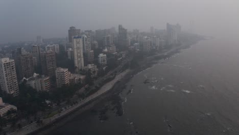 Rotating-drone-shot-of-Mumbai-coastline-on-a-hazy-day-high-tide