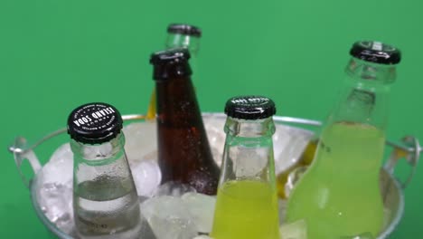 1-3-rotating-assortted-Island-Soda-carbonated-fruit-natural-drinks-in-ice-bucket-metalic-filled-cubes-background-green-screen-looped-3-part-video-for-easy-quick-advertisements