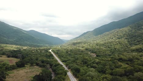 Aerial-View-of-the-Green-Plains-in-Mountains-and-Trafic-Road,-Tanzania,-Africa