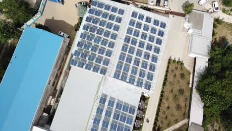 Drone-Flying-Over-Rooftop-Solar-Installation-On-Office-Warehouse-Space