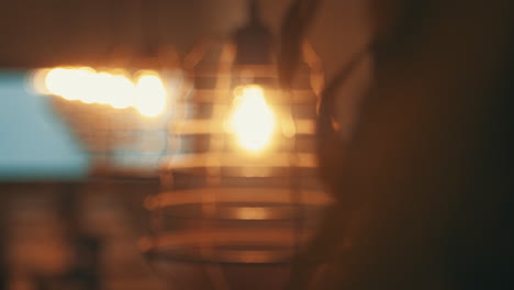 Lights-above-dining-table-in-a-restaurant-looking-cozy-while-the-focus-shifts
