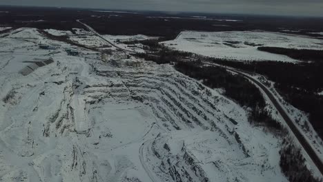 Oil-and-gold-mine-quarry-hole-in-the-cold-winter-in-Canada---Drone-4k-Aerial