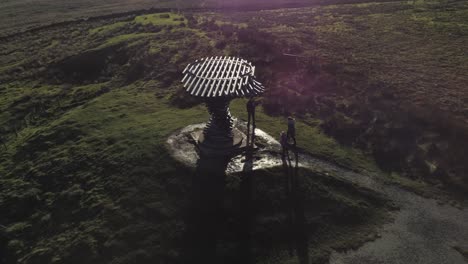 Aerial-singing-ringing-tree-musical-panopticon-sculpture-in-Lancashire-hiking-countryside-rising-sunrise-tilt-down