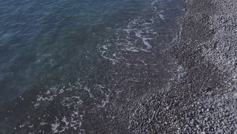 Rocky-sea-beach-shore-with-foam-aerial-view