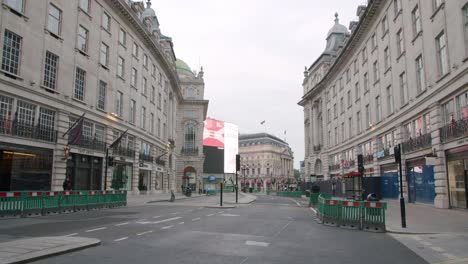 Lockdown-in-London,-slow-motion-walk-through-desolate-Regent-Street-of-Piccadilly-Circus,-during-the-COVID-19-pandemic-2020,-with-lone-walker