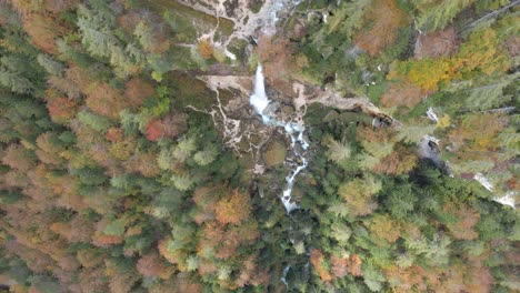 Steigender-Sockel-über-Dem-Wasserfall,-Grüne,-Gelbe-Baumwipfel,-Herbsttag
