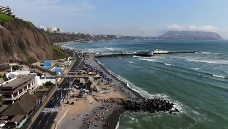 4k-aerial-daytime-panoramic-video-of-the-Makaha-beach-in-Miraflores-and-the-La-Rosa-Nautica-on-the-coastline-of-Lima,-Peru