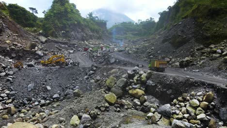 Aerial-view-of-machinery-working-open-pit-sand-mine-in-Magelang,-Indonesia