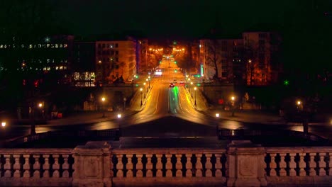 Traffic-in-Munich-at-night-with-the-view-over-the-popular-Prinzregentenstraße-in-the-central-of-the-baviarian-capital---cars-driving-stop-and-go-at-traffic-lightswith-a-smooth-zoom-out-effect
