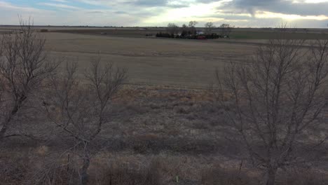 An-aerial-dolly-pan-over-trees-on-a-dry-farm-near-Sterling-Colorado-2021