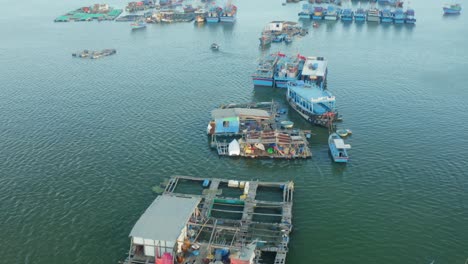 Drone-view-of-Hon-Ro-pier,-on-Nha-Trang-river,-with-many-fishing-boats-are-nailing-side-by-side