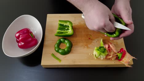 Hand-of-chef-cuts-and-cleans-green-pepper
