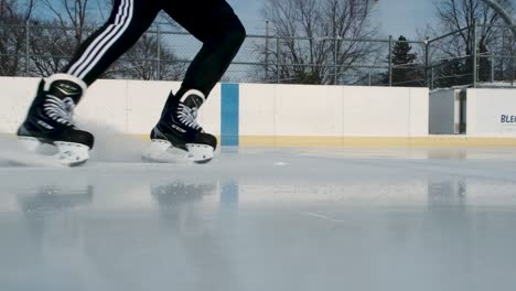 Ice-skater-stoping-and-starting-off-again-in-slow-motion-on-a-rink