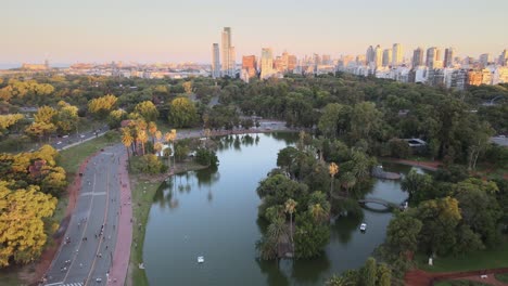 Aerial-dolly-out-of-Rosedal-gardens-and-pond-near-pedestrian-street-in-Palermo-neighborhood-at-sunset,-Buenos-Aires