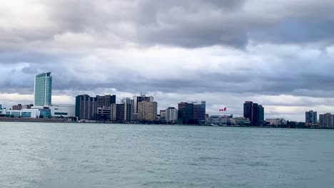 Detroit-river-waterfront-with-Windsor,-Canada-in-the-background