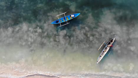 Fisherman-on-their-man-made-boats-working-just-off-the-beach-over-shallow-reef