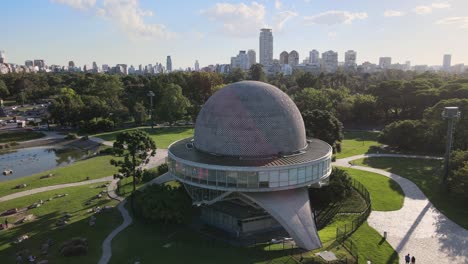 Aerial-of-Galileo-Galilei-Planetarium-in-Palermo-Woods-with-building-in-background-at-daytime,-Buenos-Aires