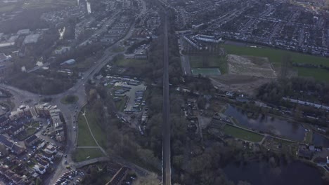 Stable-wide-drone-shot-of-long-straight-railway-in-suburban-UK-Watford-London