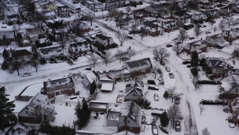 an-aerial-view-over-a-suburban-neighborhood-in-the-morning,-after-a-snow-storm