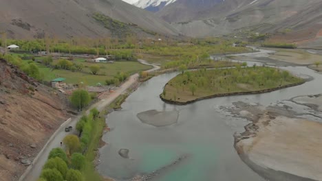 Aerial-View-Along-Road-Beside-River-In-Ghizer-Valley-District-In-Pakistan