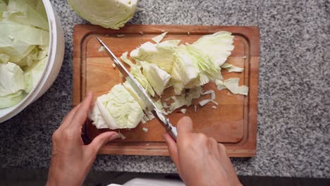 Hands-Cutting-White-Cabbage-In-Slow-Motion
